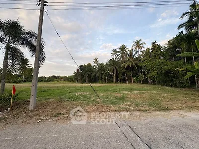 Spacious land plot with lush greenery and palm trees, ideal for development or investment opportunities.
