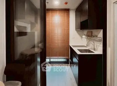 Modern compact kitchen with sleek cabinetry and natural light