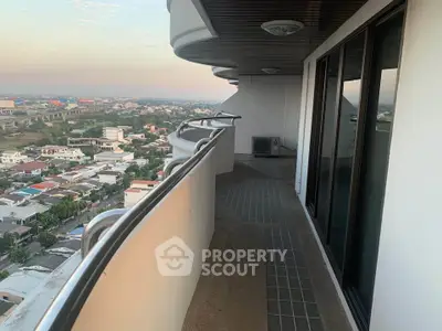 Spacious balcony with stunning city view in modern high-rise building.
