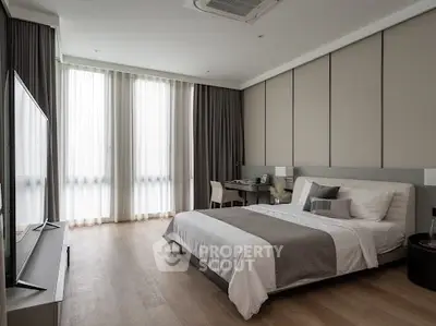 Modern bedroom with elegant decor and large windows for natural light