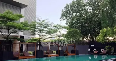 Luxurious modern pool area with stylish cabanas and lush greenery