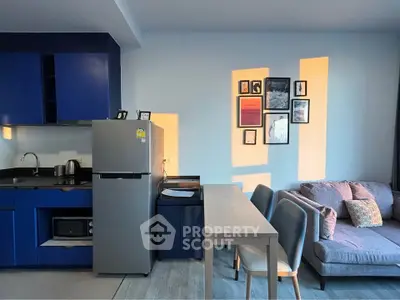 Modern apartment interior with blue kitchen, cozy living area, and stylish decor.