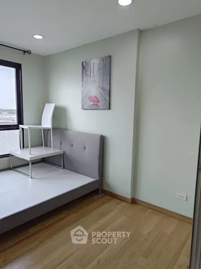 Modern bedroom with minimalist decor and large window view