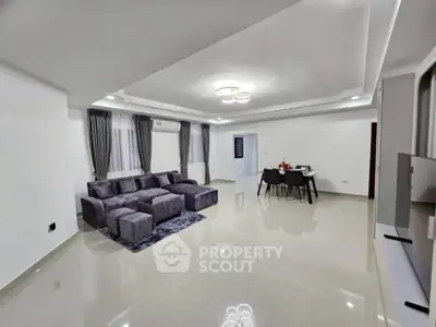 Spacious modern living room with sleek furniture and dining area