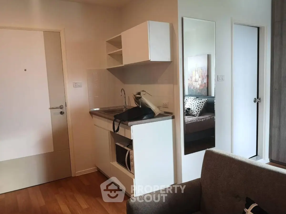 Cozy studio apartment with compact kitchen and modern decor