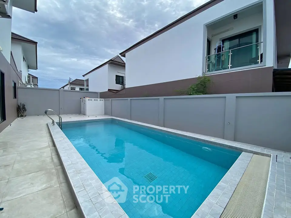 Modern residential property with private pool and elegant architecture.