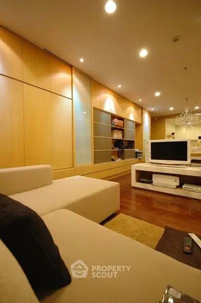 Spacious modern living room with elegant lighting and stylish furniture.