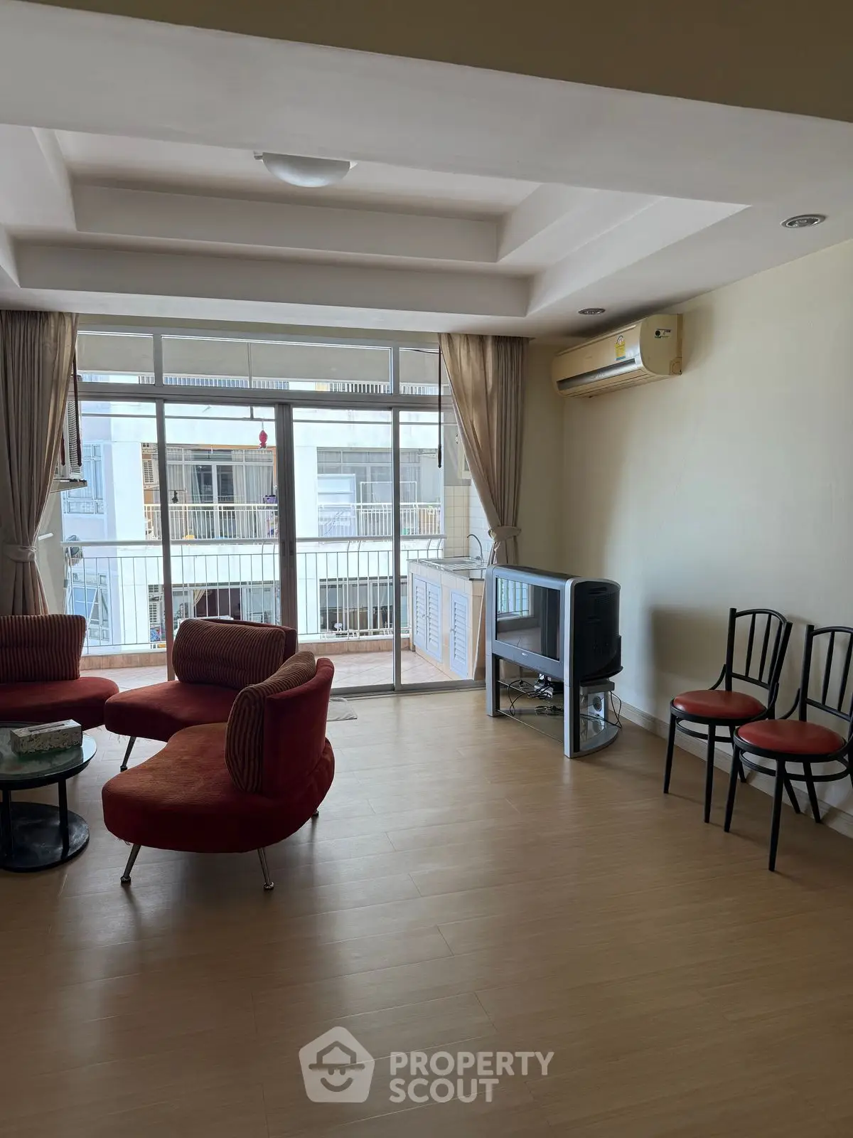 Spacious living room with modern furniture and large windows for natural light.