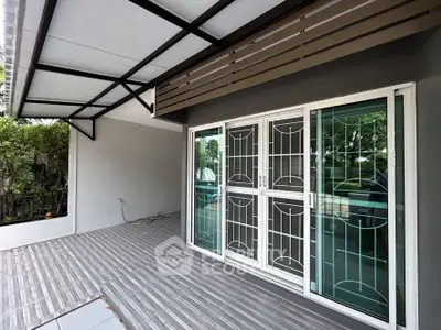 Spacious modern balcony with sliding glass doors and garden view