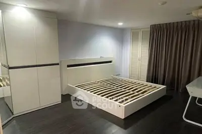 Spacious modern bedroom with sleek flooring and ample closet space.