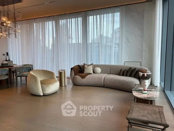 Luxurious modern living room with elegant furniture and large windows