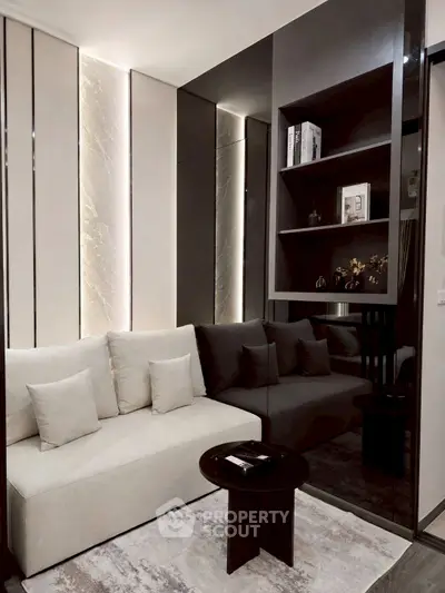 Modern living room with sleek design, featuring a cozy sofa, elegant shelving, and ambient lighting.