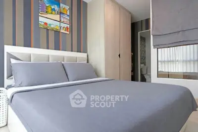Modern bedroom with stylish decor and cozy bedding in a contemporary apartment.