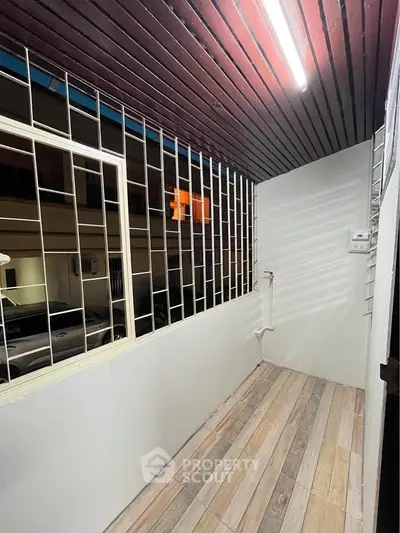 Charming balcony with wooden ceiling and tiled floor, perfect for relaxation.