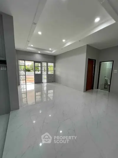 Spacious modern living room with glossy marble floors and large windows