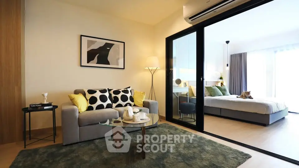 Modern living room with cozy sofa and stylish decor adjacent to a bright bedroom.