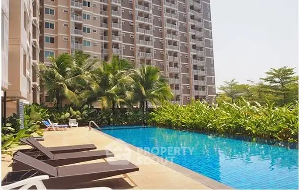 Luxurious apartment complex with stunning pool and lush greenery