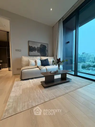 Modern living room with city view, featuring elegant decor and large windows for natural light.