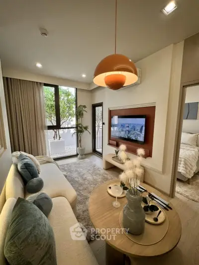 Modern living room with cozy sofa and stylish decor, featuring a large window and natural light.