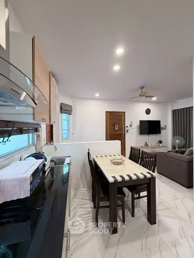 Modern open-plan kitchen and living room with sleek design and dining area