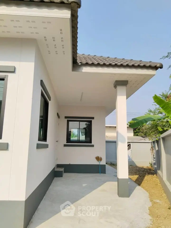 Charming single-story home with modern exterior and spacious driveway