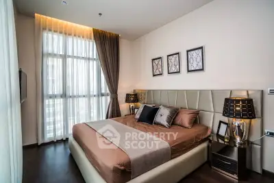 Luxurious bedroom with elegant decor and large window for natural light