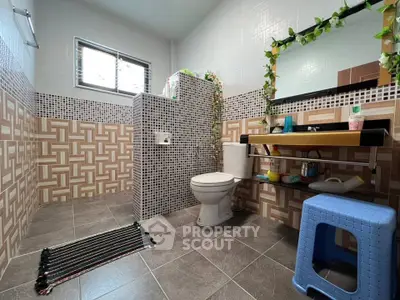 Modern bathroom with stylish tile design and functional fixtures