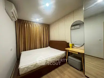 Modern bedroom with cozy bed, stylish mirror, and elegant curtains in a contemporary apartment.