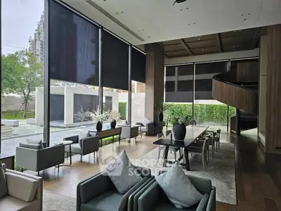 Luxurious modern living room with floor-to-ceiling windows and elegant furnishings overlooking a serene garden.