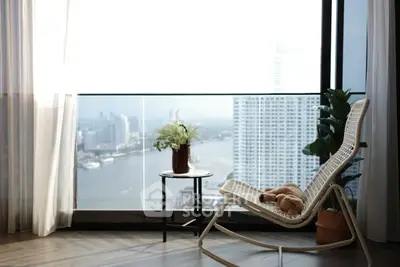Luxurious high-rise balcony with stunning river view and elegant seating area.