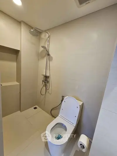 Modern bathroom with sleek shower and toilet design in minimalist style.