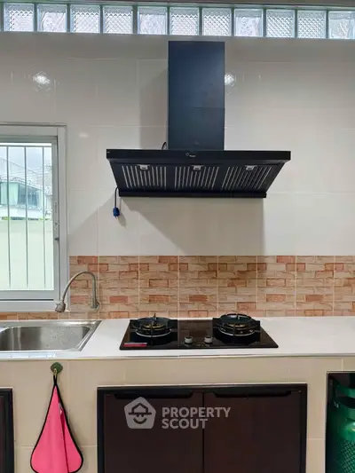 Modern kitchen with gas stove and sleek range hood