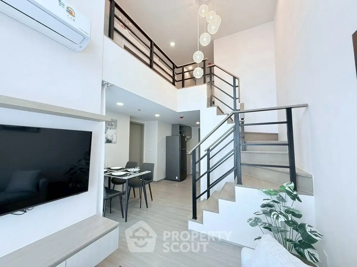 Modern duplex apartment with stylish staircase and open living area