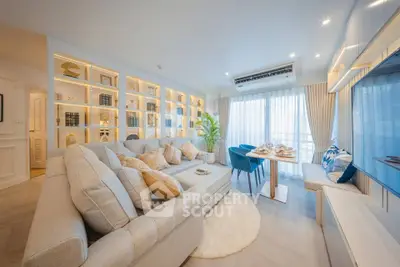 Luxurious living room with elegant decor and ample natural light, featuring a cozy sectional sofa and stylish dining area.