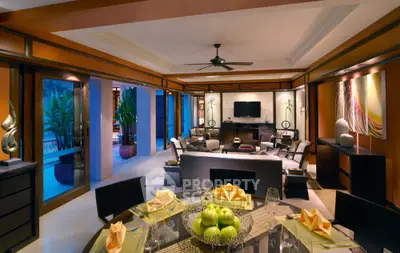 Luxurious open-plan living room with pool view and elegant decor