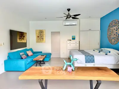 Spacious modern living room with vibrant blue accents and stylish decor