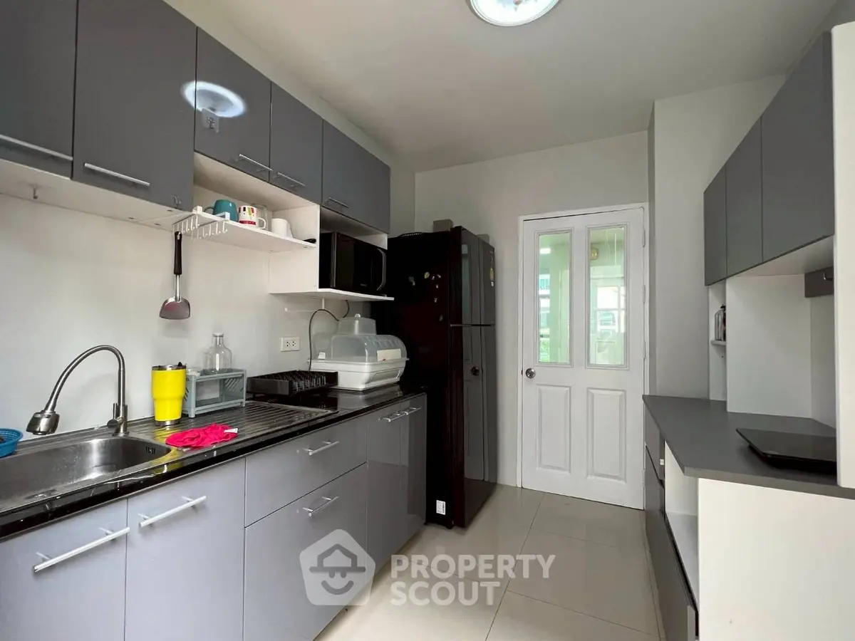 Modern kitchen with sleek gray cabinets and stainless steel sink