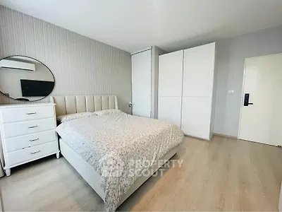 Modern bedroom with stylish decor and ample storage space