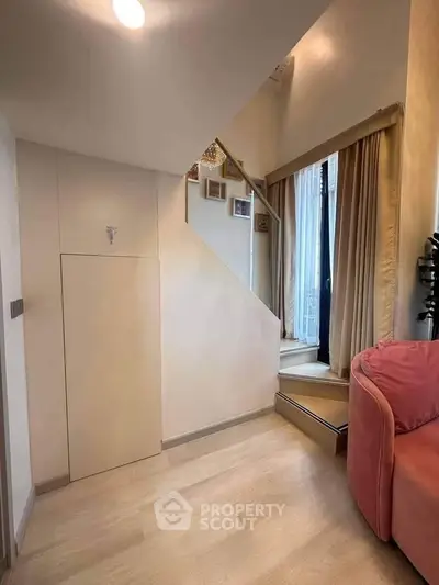 Charming interior with staircase and cozy seating area, perfect for modern living.