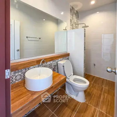 Modern bathroom with stylish wooden accents and elegant tile design