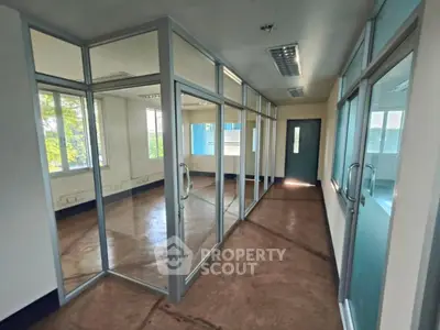 Spacious office space with glass partitions and natural light