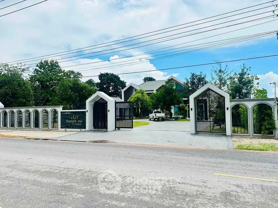 Stunning gated property with lush greenery and modern architecture, perfect for luxury living.