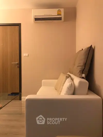 Cozy living room with modern sofa and air conditioning unit