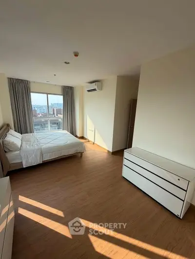 Spacious bedroom with city view and modern furnishings