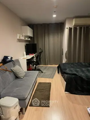 Modern studio apartment with cozy living area and workspace