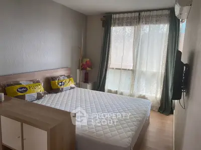 Cozy bedroom with natural light, modern decor, and comfortable bedding in a stylish apartment.
