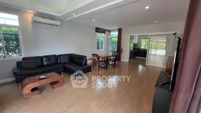 Spacious living room with modern furniture and open layout, perfect for family gatherings.