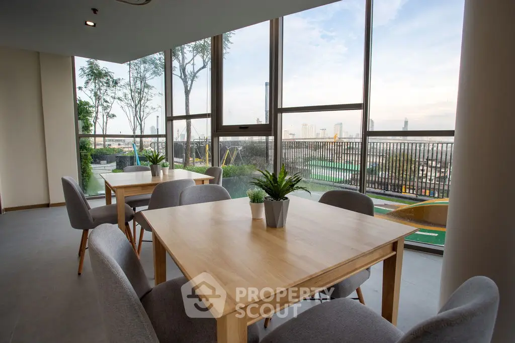 Modern dining area with large windows and city view