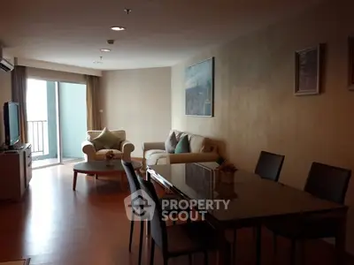Spacious living room with modern furniture and balcony access