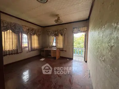 Spacious room with vintage curtains and wooden flooring, featuring a small balcony with garden view.